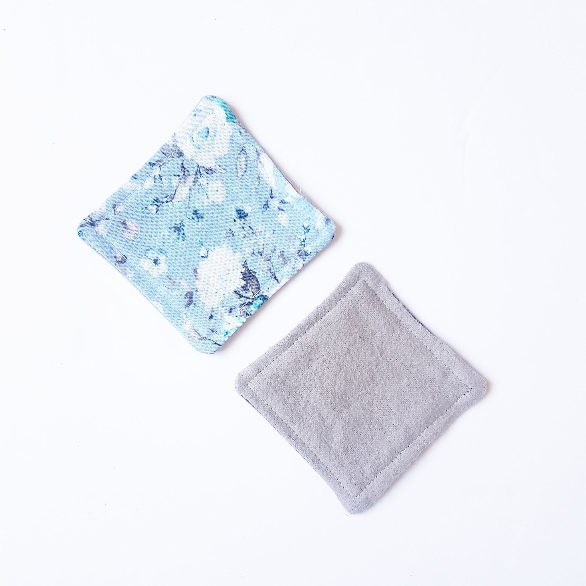 Coasters with floral pattern and gray fabric, square shape, two pieces shown