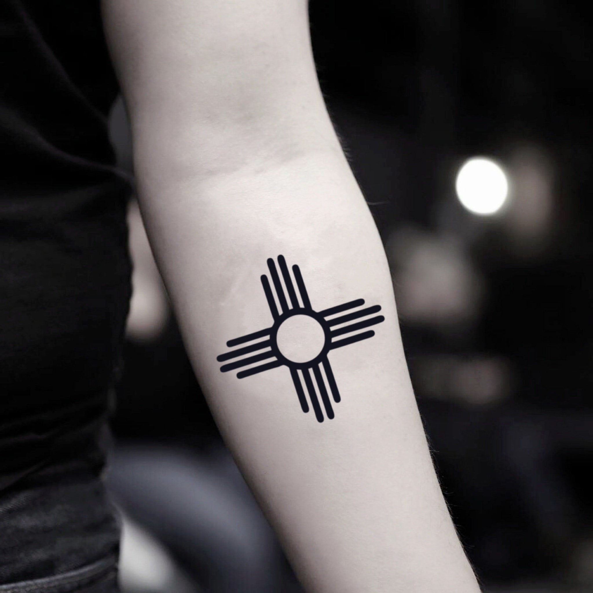 Two delicate Zia symbol temporary tattoo stickers with intricate sunray designs on clear backing