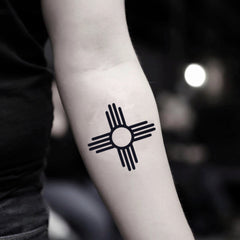 Two delicate Zia symbol temporary tattoo stickers with intricate sunray designs on clear backing