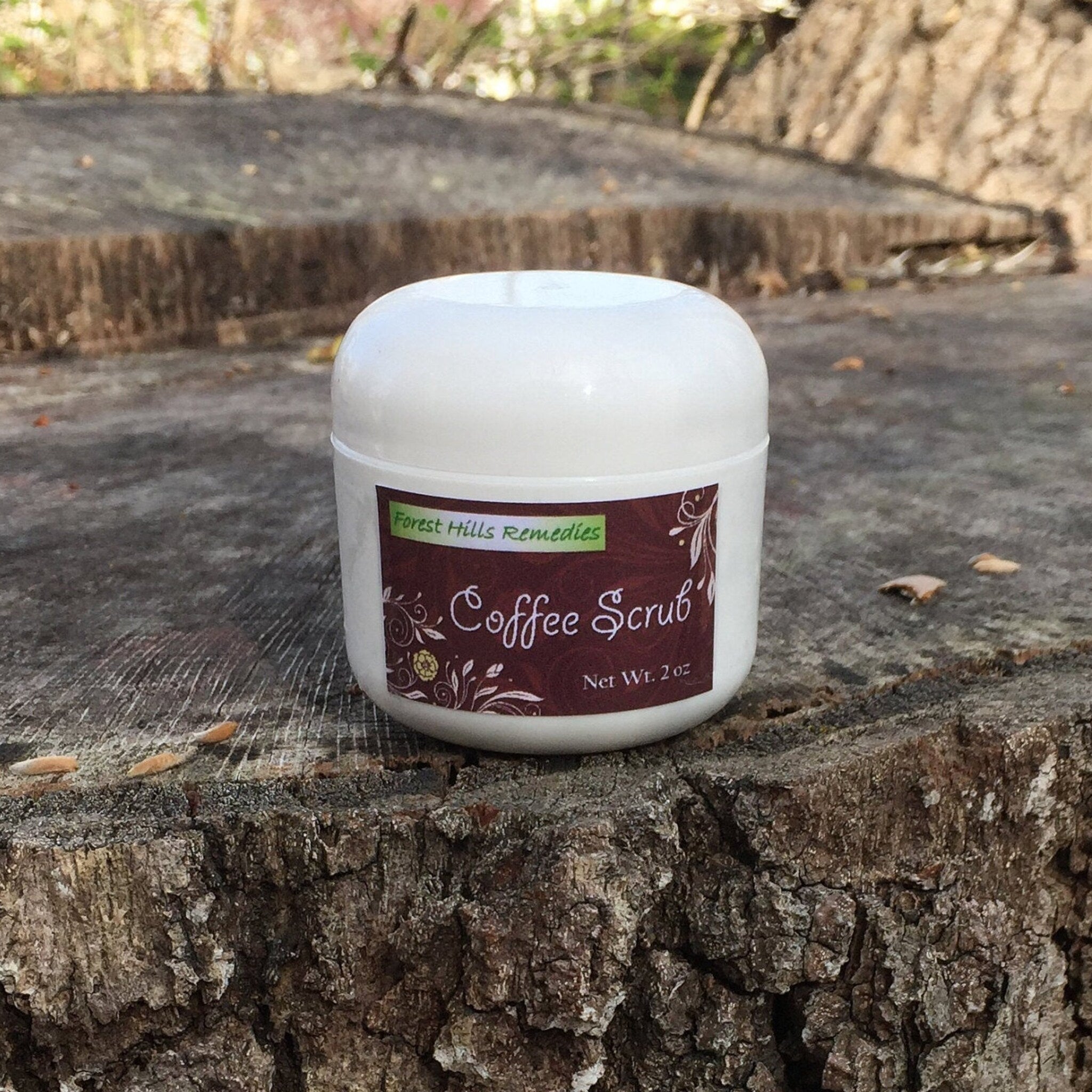 Coffee scrub jar, white plastic container, dark brown label with text "Coffee Scrub" by Forest Hills Remedies