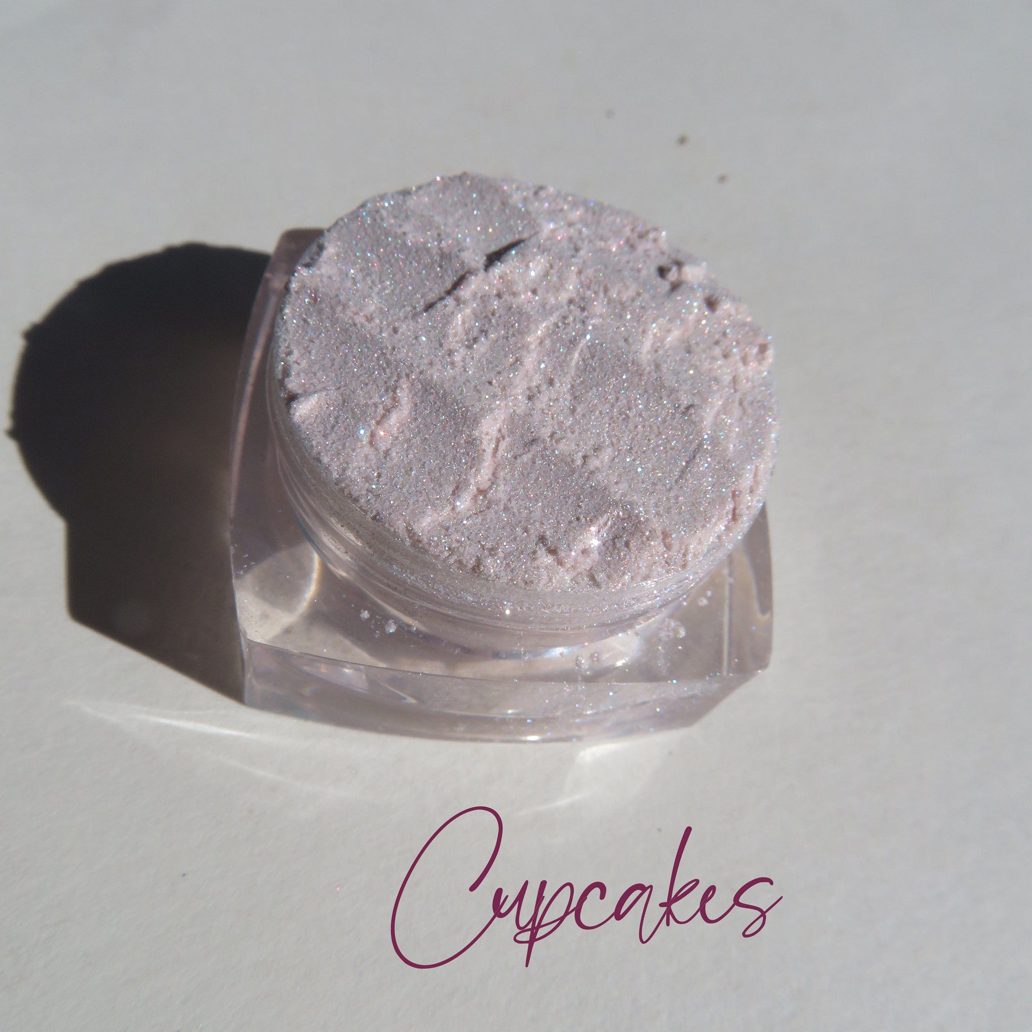Side view of vegan mineral eye shadows in assorted matte and shimmer shades with loose powder liners