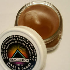 Skin care lotion in clear glass jar with brown cream and white lid, Mane & Glory brand visible