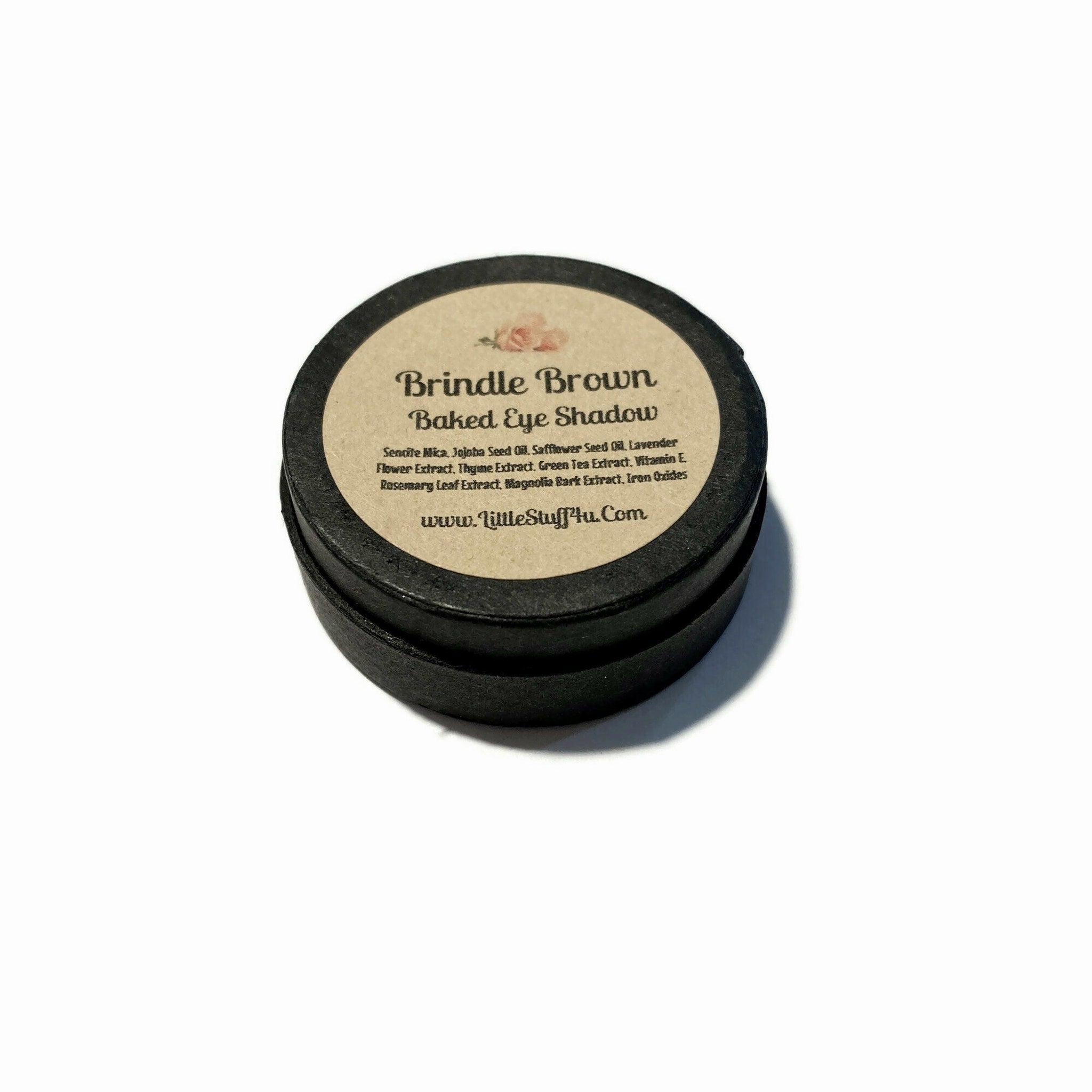 Brindle Brown baked eyeshadow compact with botanical ingredients, shown open on marble surface