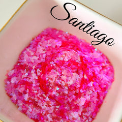 Loose glitter eyeshadow, pink holographic glitter, in a pink dish, with "Santiago" text