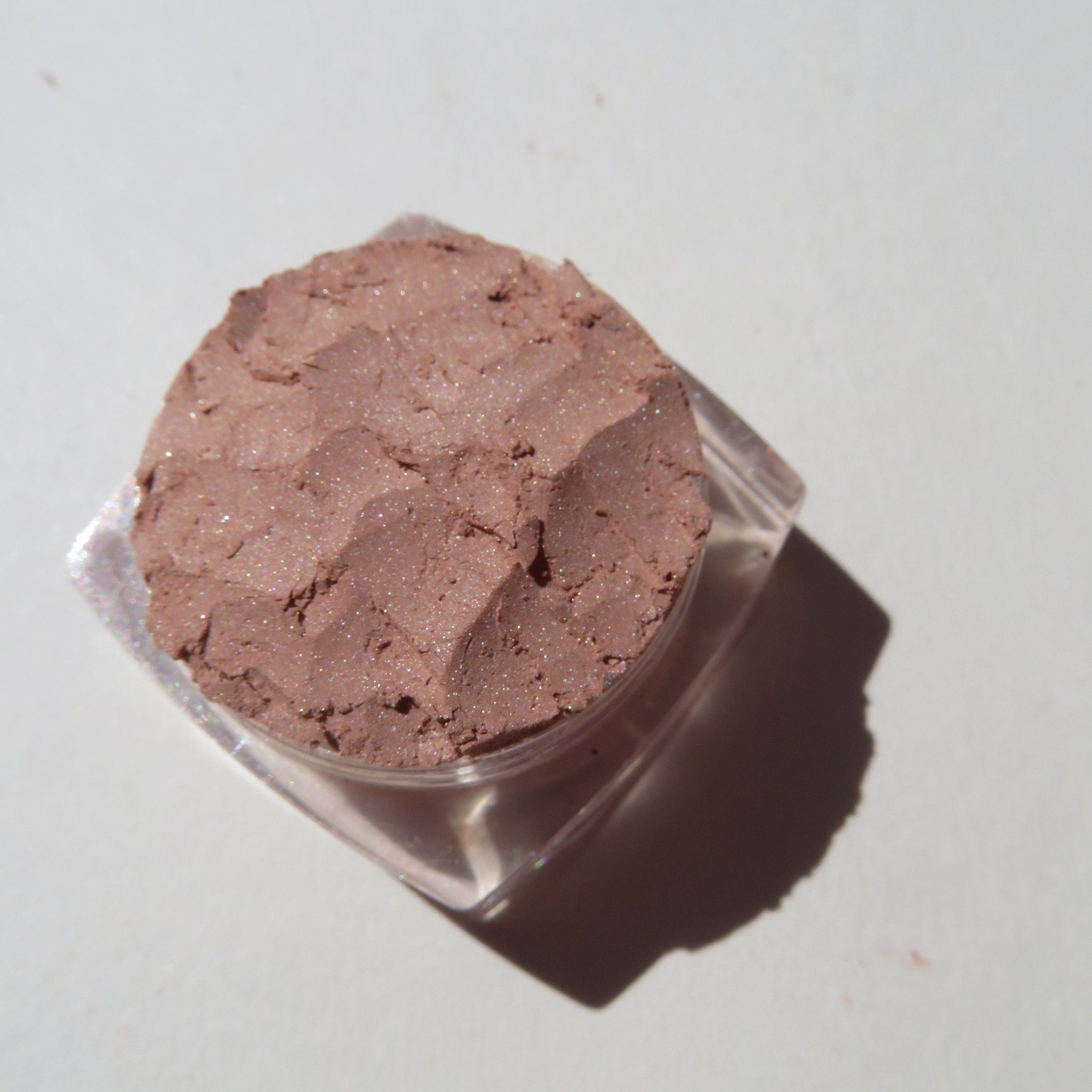 Open compact showing matte brown loose mineral eyeshadow with vegan and cruelty-free label visible