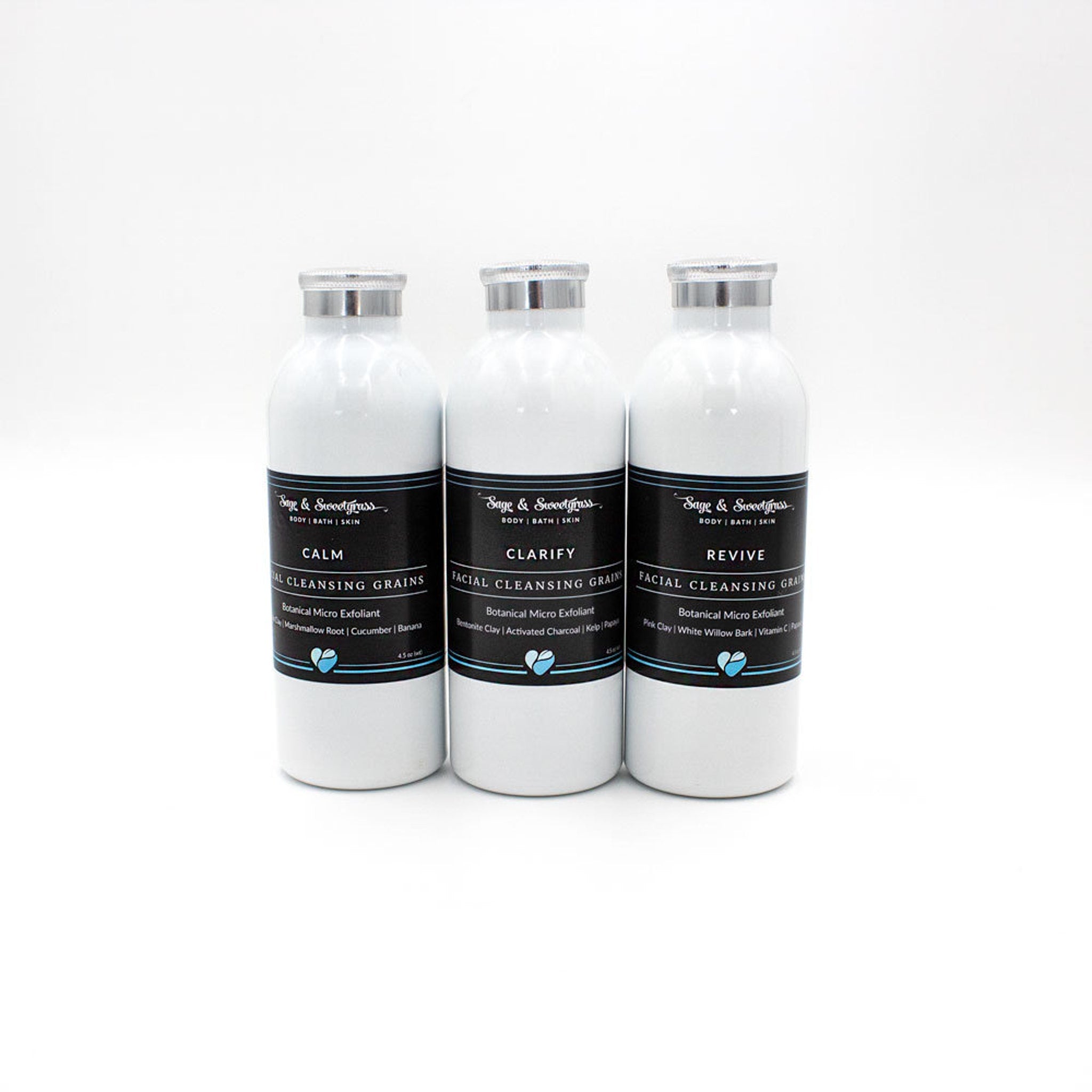Facial Cleansing Grains in white bottles with silver lids, Sage & Sweetgrass brand label visible