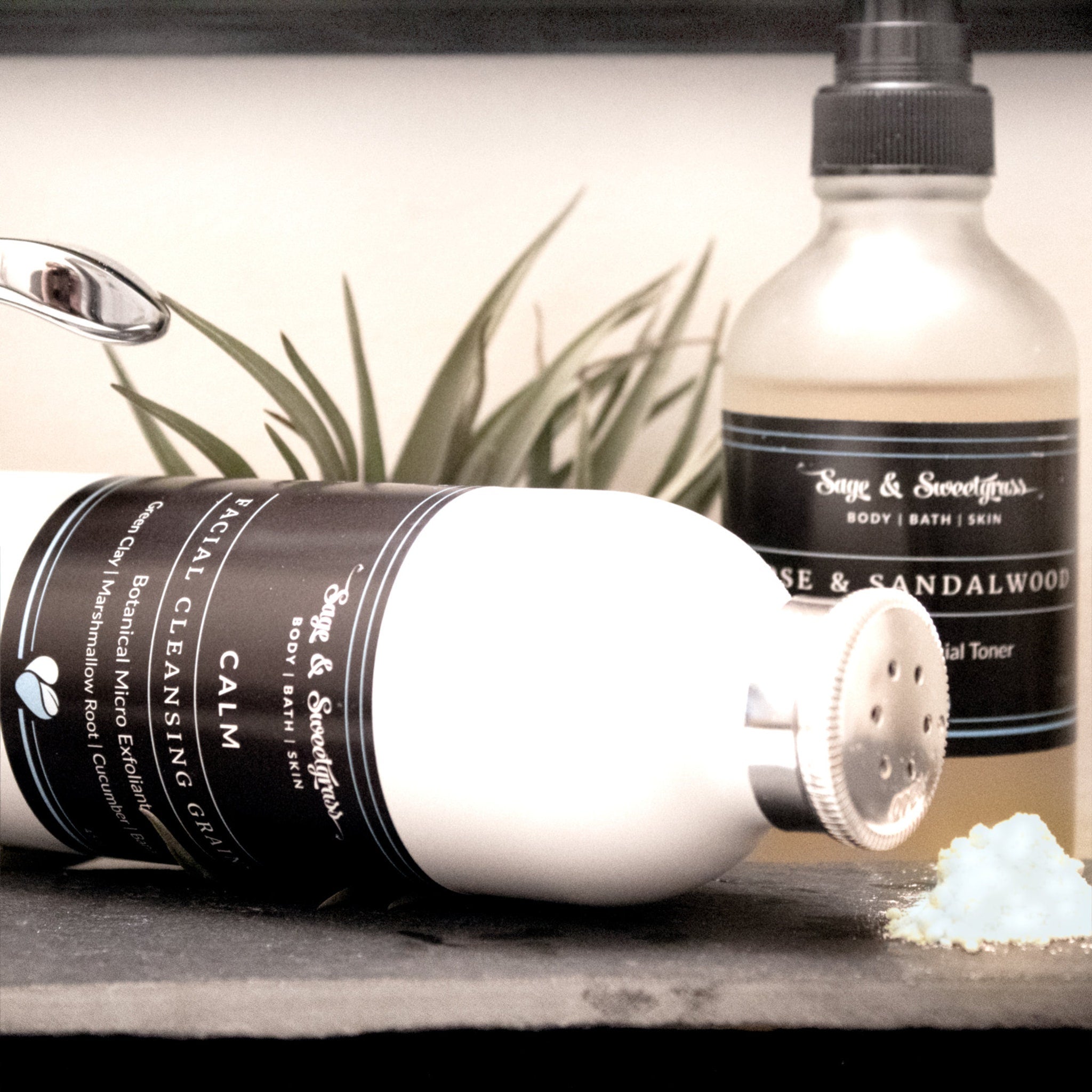 Facial Cleansing Grain with white bottle, black label, and Sage & Sweetgrass branding, powder visible