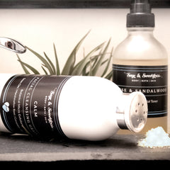 Facial Cleansing Grain with white bottle, black label, and Sage & Sweetgrass branding, powder visible