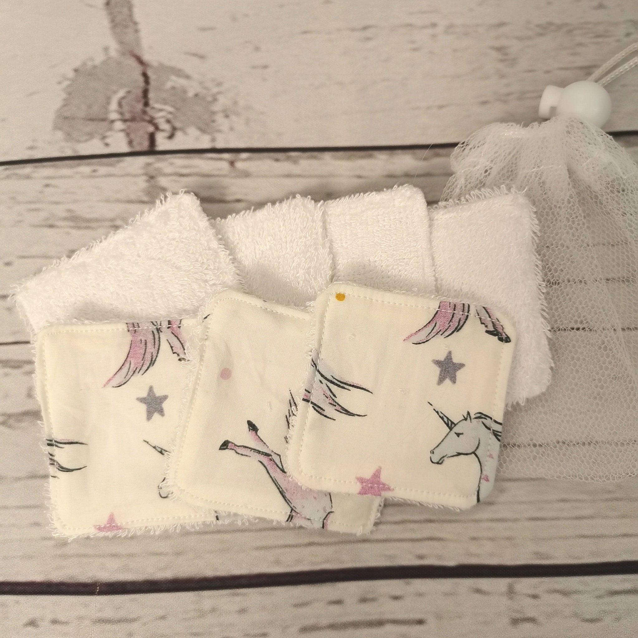 Washable face pads with unicorn print, white terry cloth, and mesh bag for washing