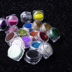 Glitter eye shadow palette with vibrant shimmer shades in a sleek black compact case