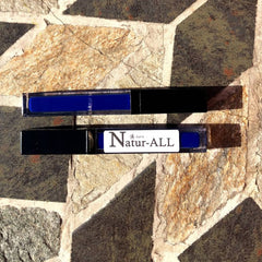 Lip gloss tubes, black plastic, blue liquid, Natur-ALL brand visible on label