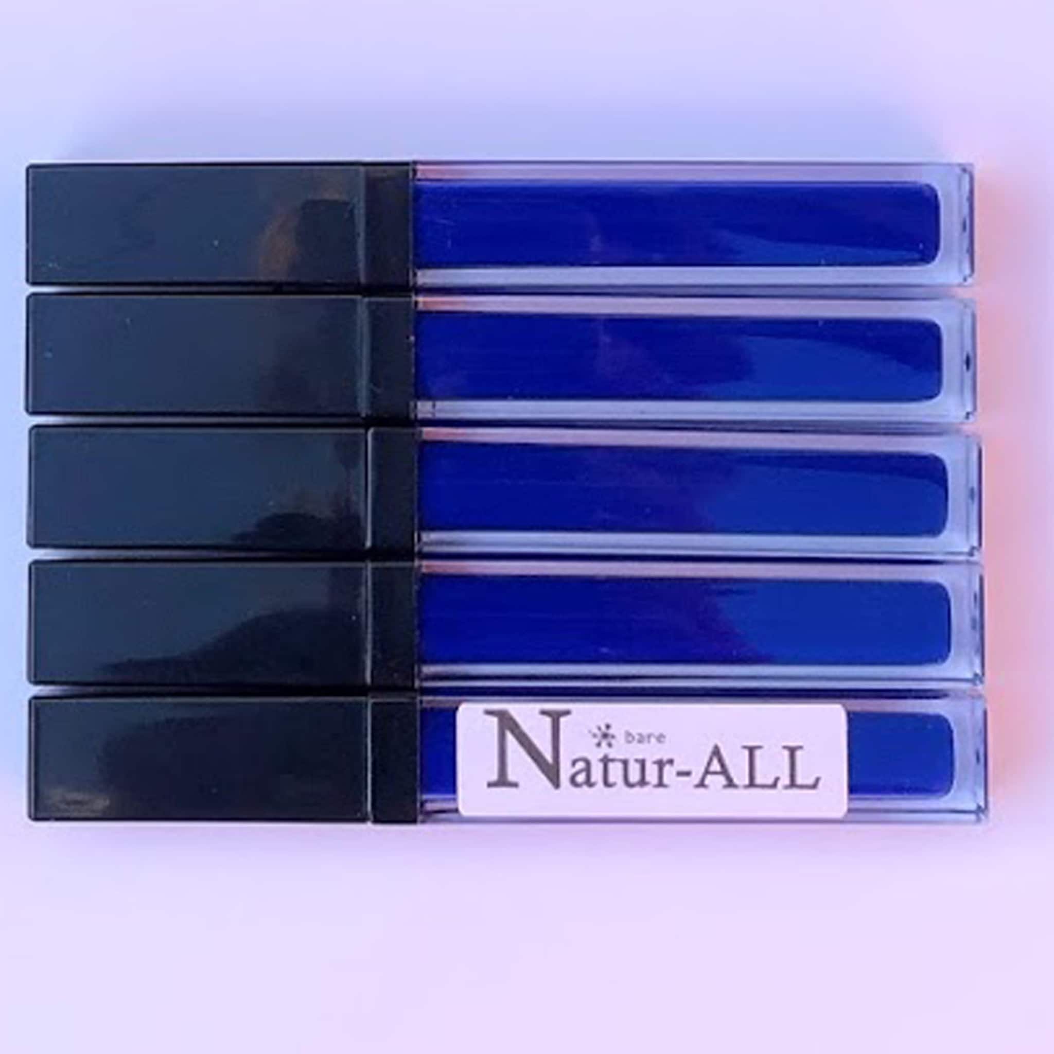 Lip gloss tubes in blue with black caps, Natur-ALL branding visible on label