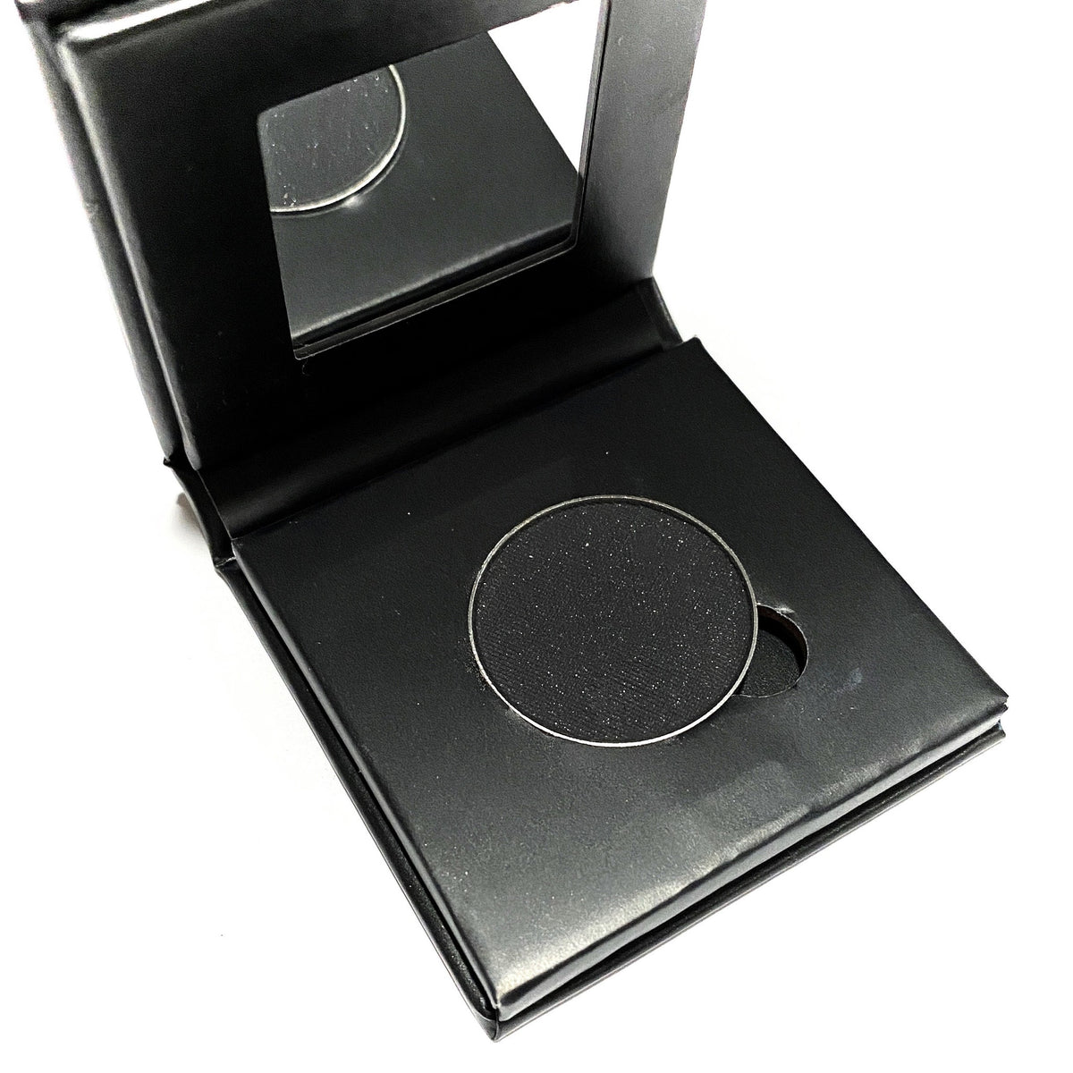 Black matte pressed mineral eyeshadow in compact with sleek silver casing and vegan makeup label