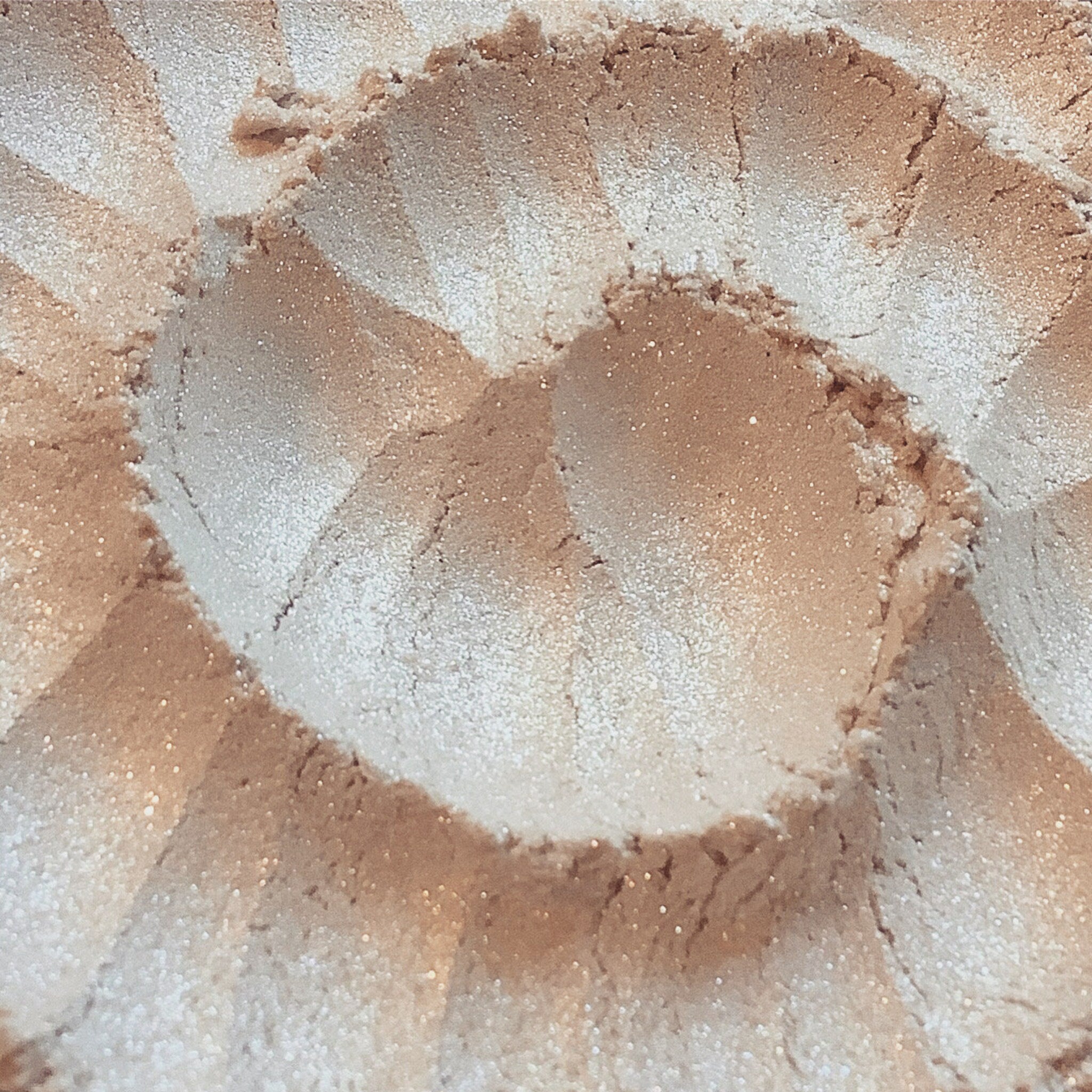 Close-up of Vanilla Twist loose eyeshadow jar showing pale ivory powder with silver and white shimmer particles