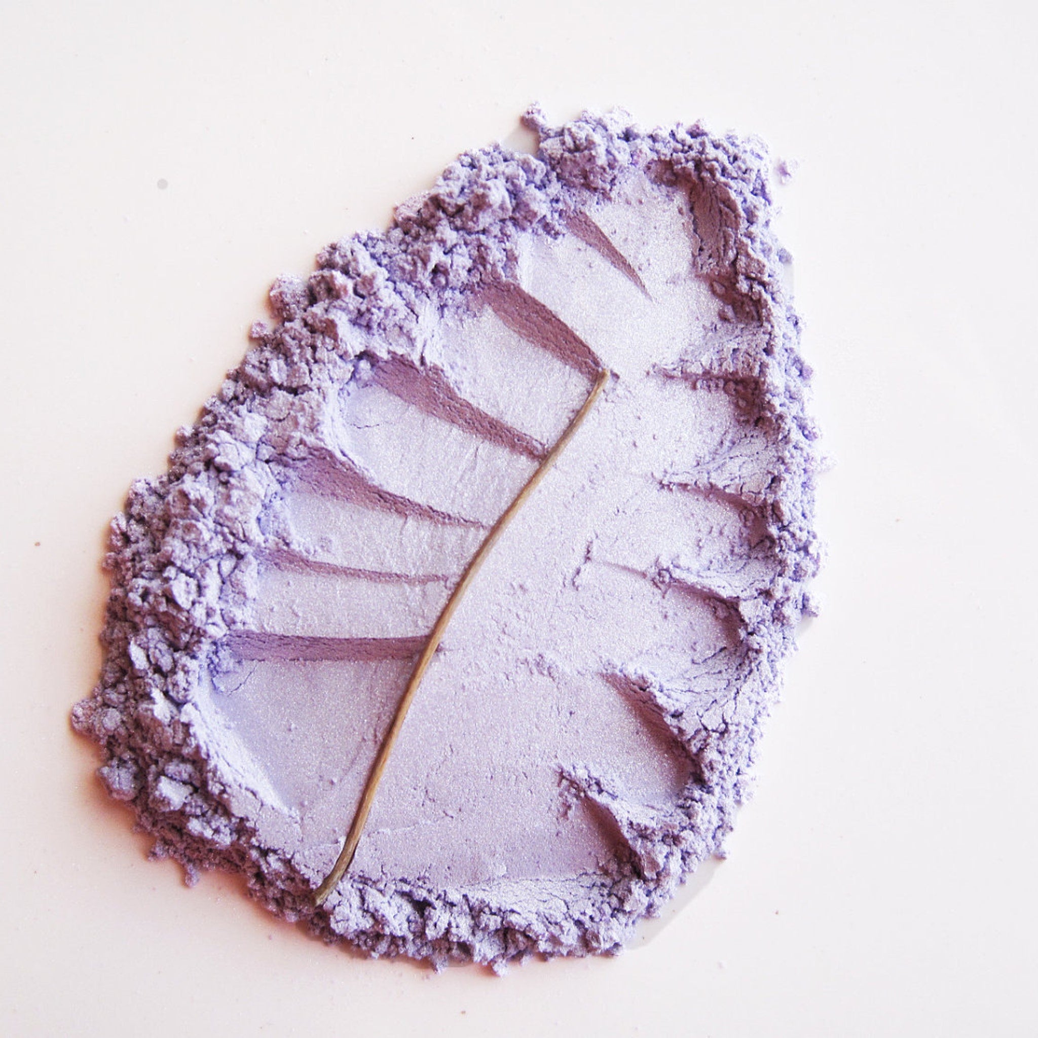 Close-up of Pure Natural Mineral Eye Shadow in Candied Violet, a soft lilac powder with shimmer finish in compact case