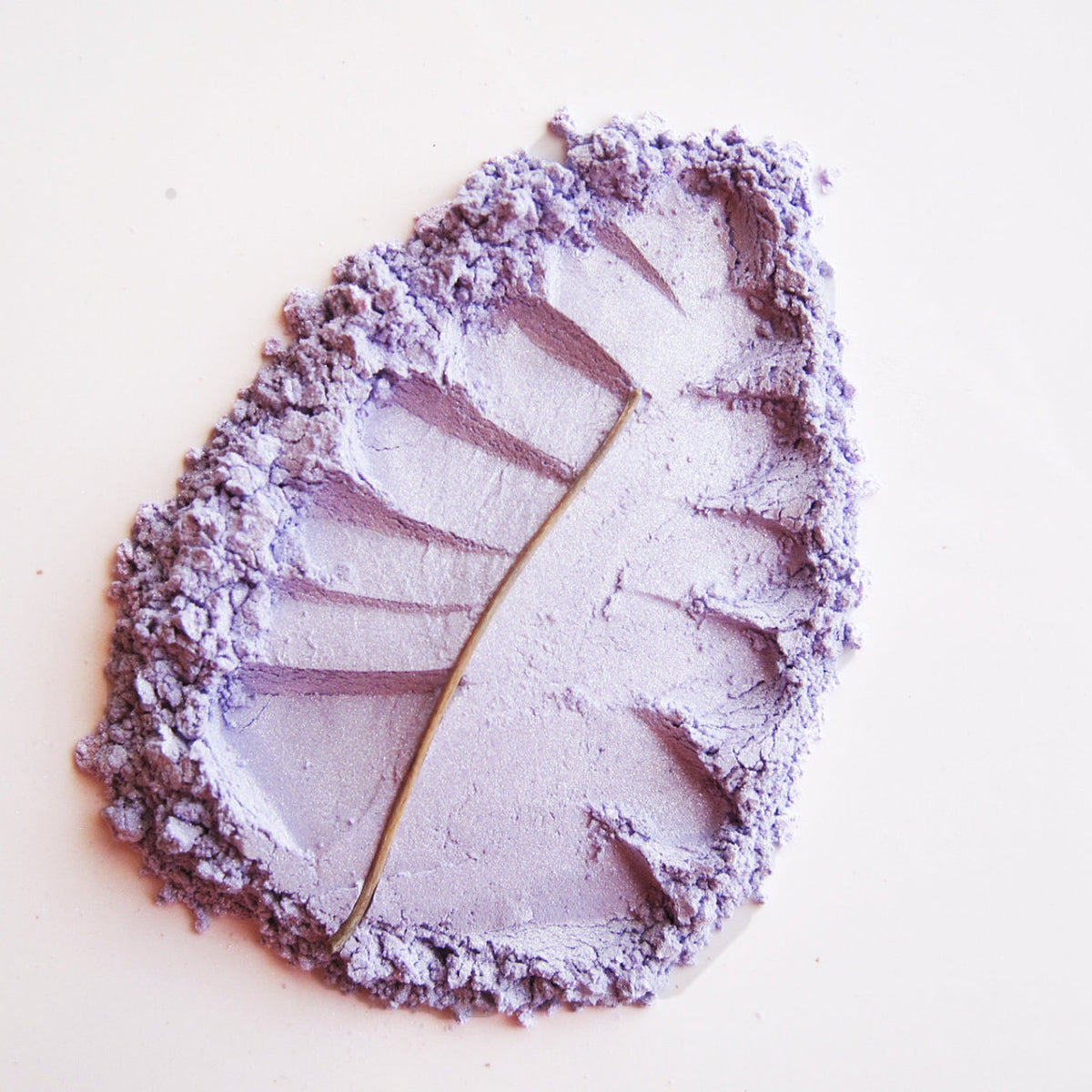 Close-up of Pure Natural Mineral Eye Shadow in Candied Violet, a soft lilac powder with shimmer finish in compact case