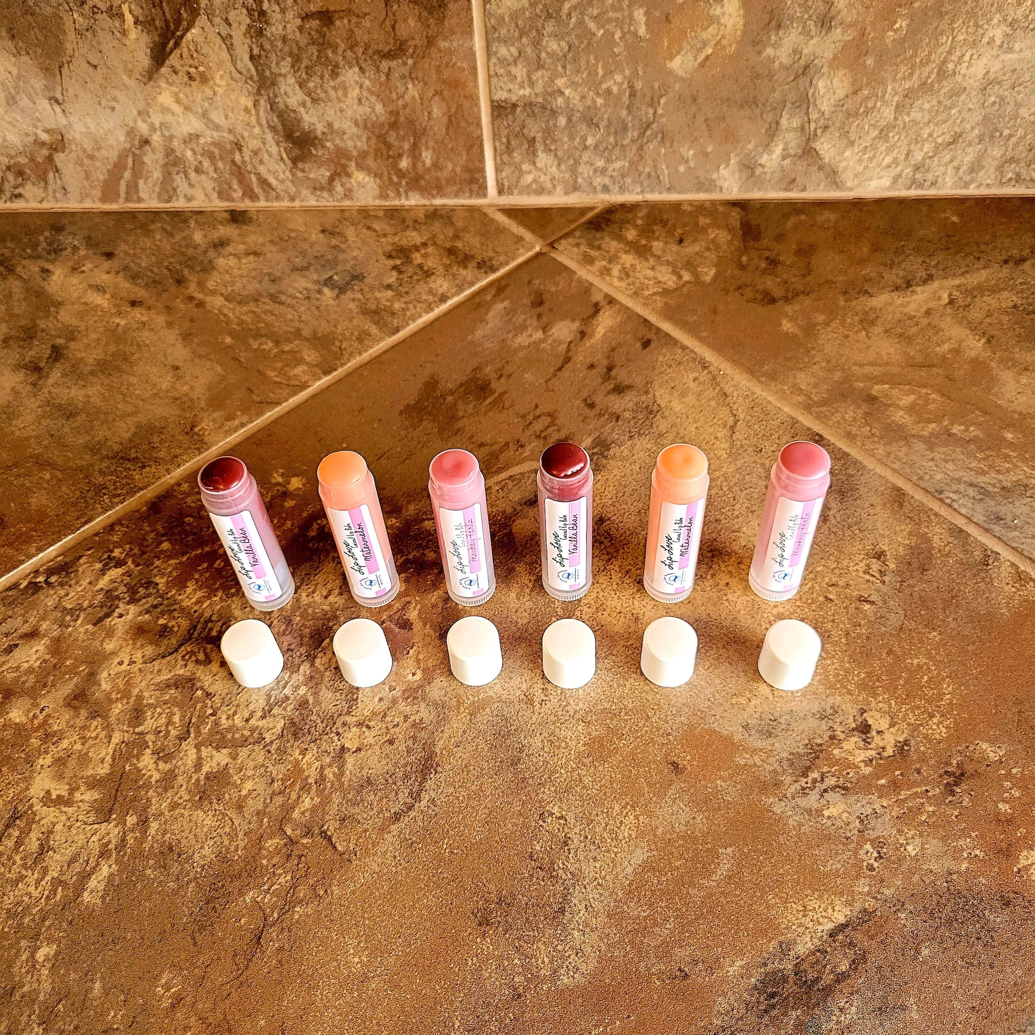 Lip balm tubes in various colors with white caps, Bubble Love Boutique lip care products