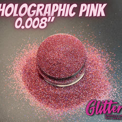 Close-up of holographic pink glitter eyeshadow with ultrafine shimmer in a compact pan
