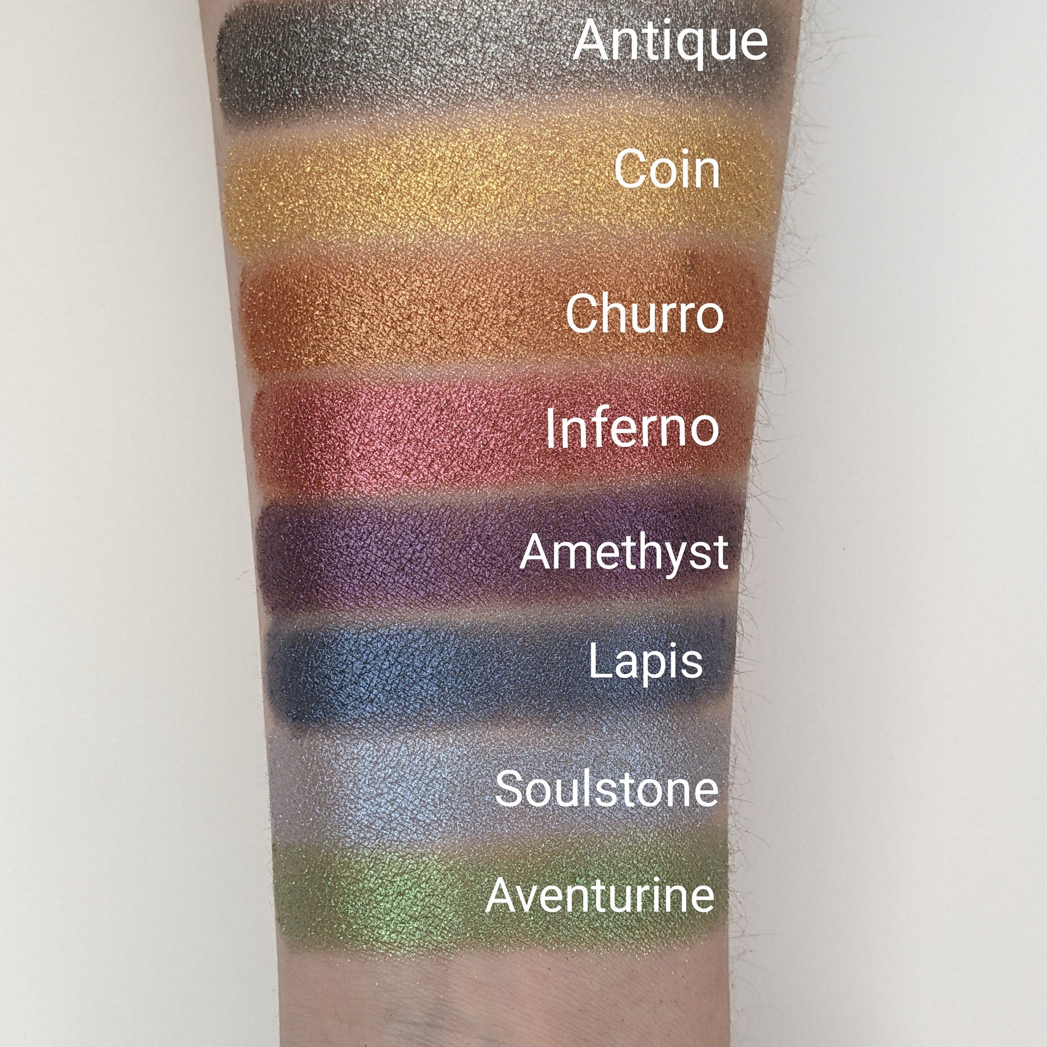 Close-up of bronze shimmer pressed eyeshadow with vegan churro-inspired warm tones and smooth metallic finish