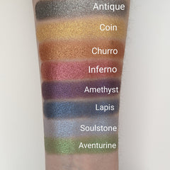 Close-up of bronze shimmer pressed eyeshadow with vegan churro-inspired warm tones and smooth metallic finish