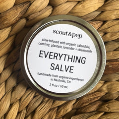 Salve tin with white label, silver rim, and woven brown background, Scout & Pep brand