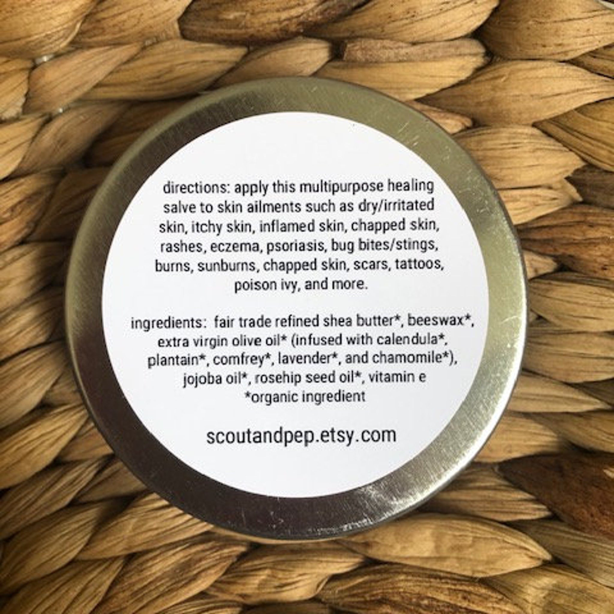 Healing salve in a silver tin with white label, on woven background, scoutandpep etsy text visible