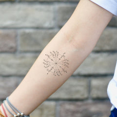 Two circular skin-friendly tattoo stickers with minimalist design, packaged side by side on clear backing