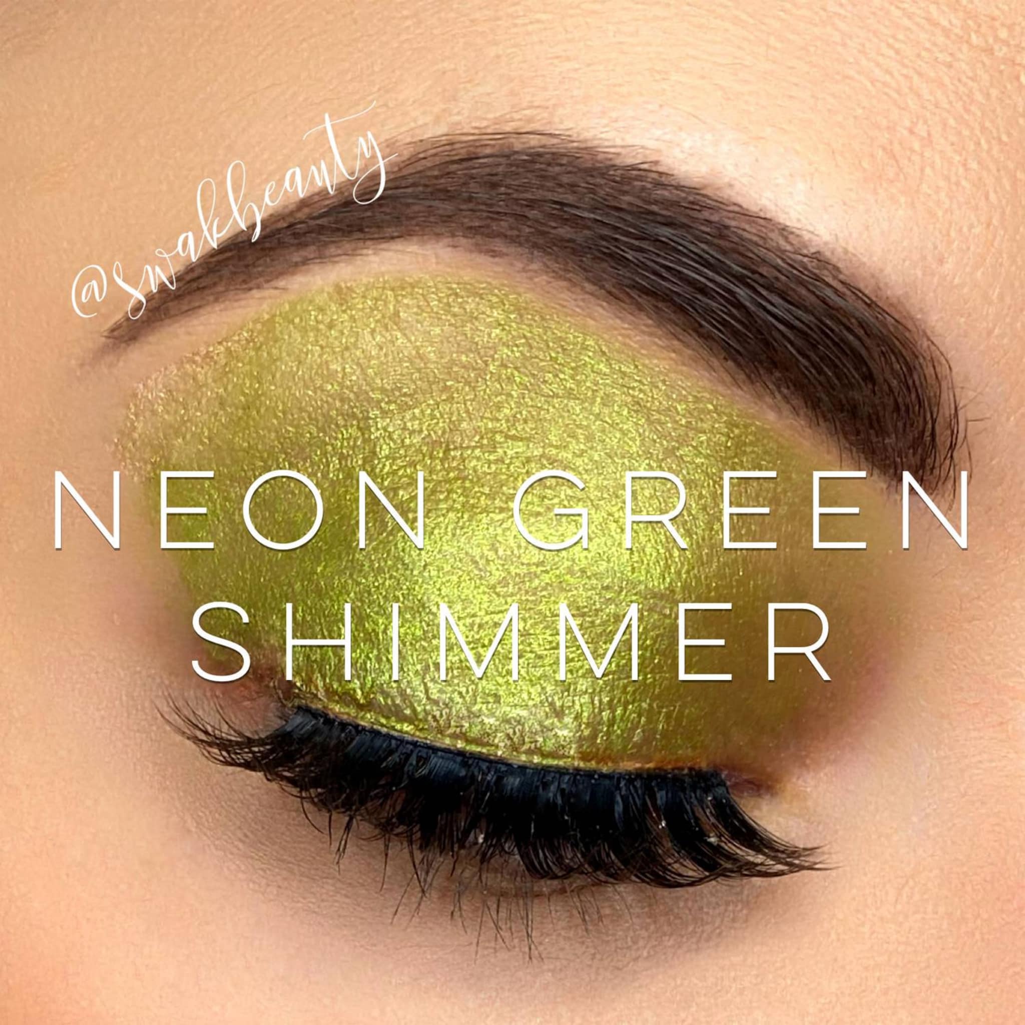 Neon green shimmer eyeshadow applied to eyelid with @swakbeauty text visible