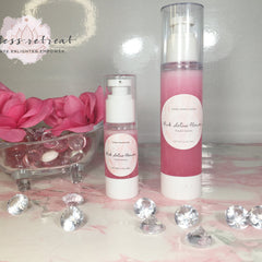 Facial cleanser bottles with pink liquid, white pump, and Goddess Retreat Boutique label on marble surface