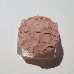 Close-up of matte brown loose mineral eyeshadow with rich coffee latte pigment texture