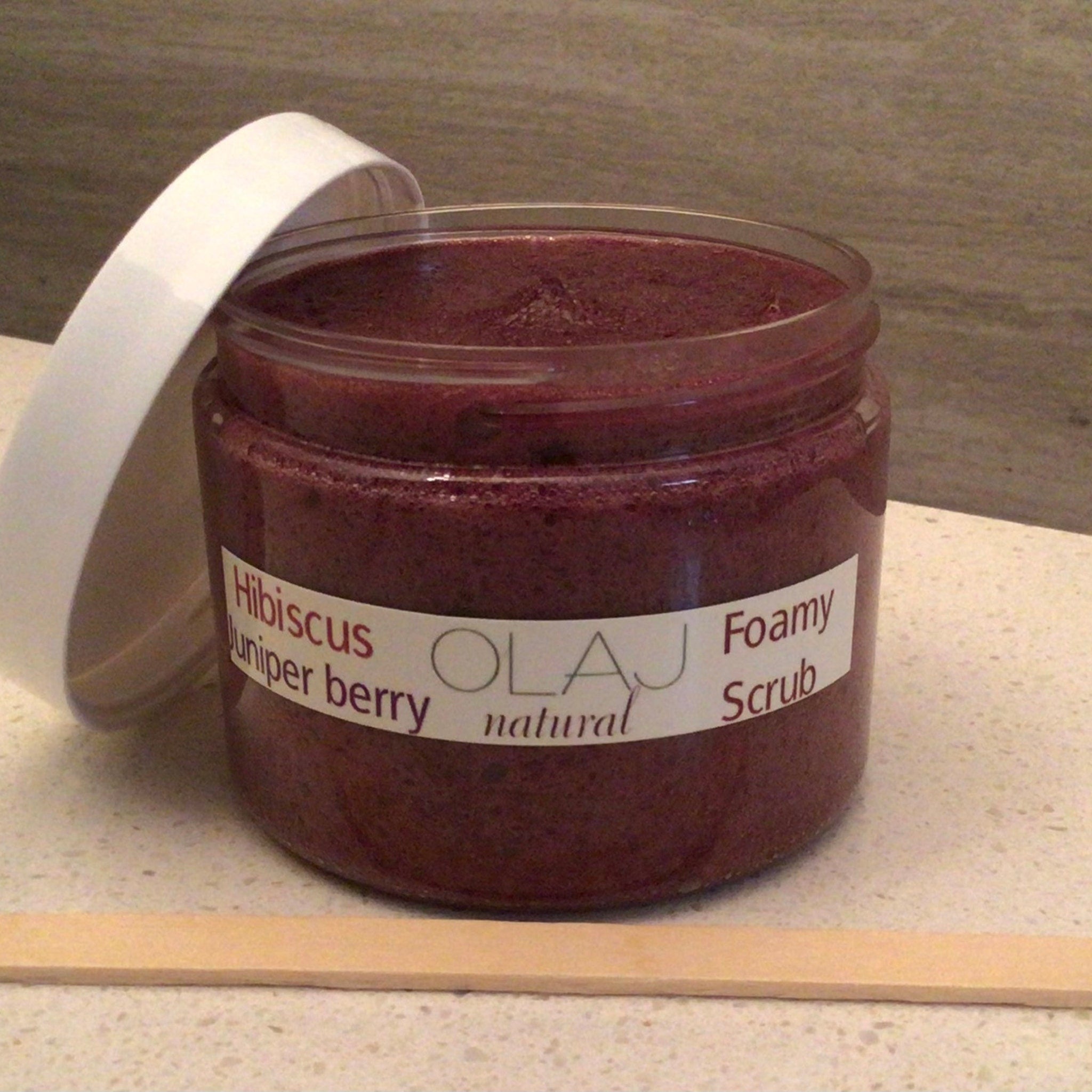 Foamy scrub jar with dark red color and white lid, OLJ natural label visible