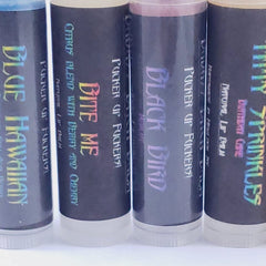 Lip balm tubes with black and white labels, holographic text, and clear base