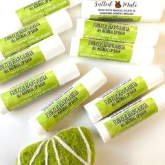 Lip balm tubes with white and green labels, text "Frozen Margarita", and a green felt ball