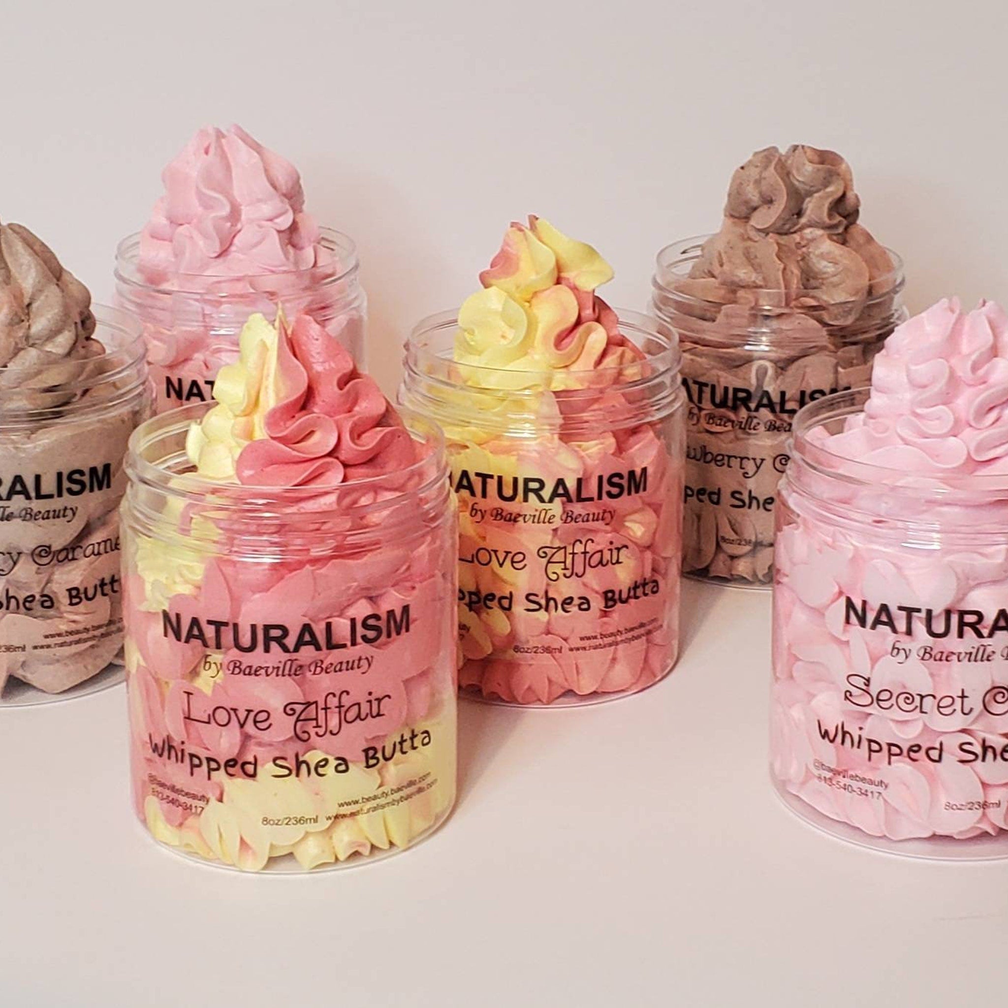 Whipped shea butter in clear jars, pink and yellow swirl, Baeville Beauty branding visible