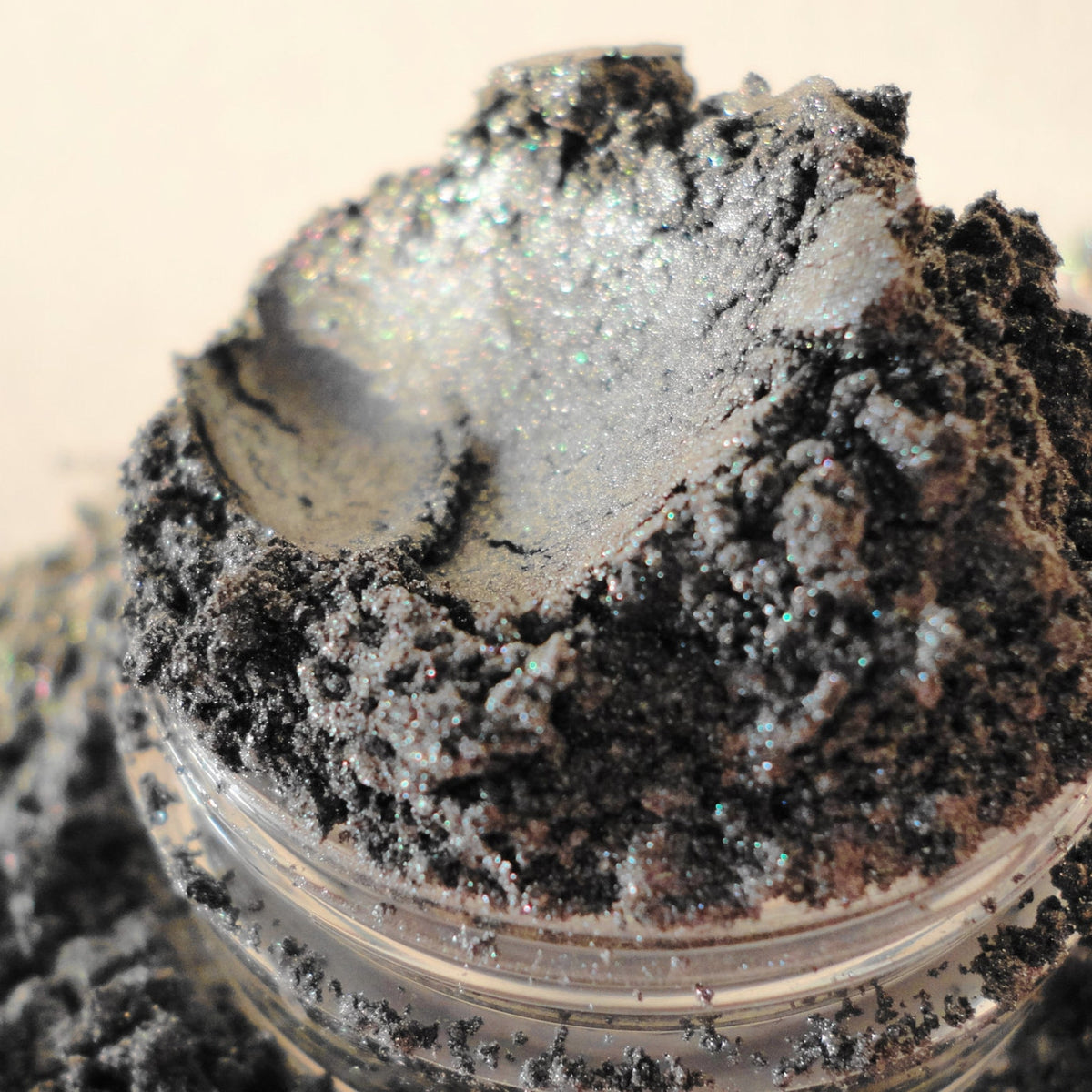 Dark silver metallic eyeshadow pan with intense shimmer finish for smokey eye looks