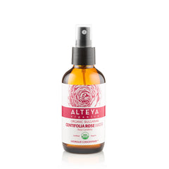 Rose water bottle with brown glass, black cap, and white label with ALTEYA branding