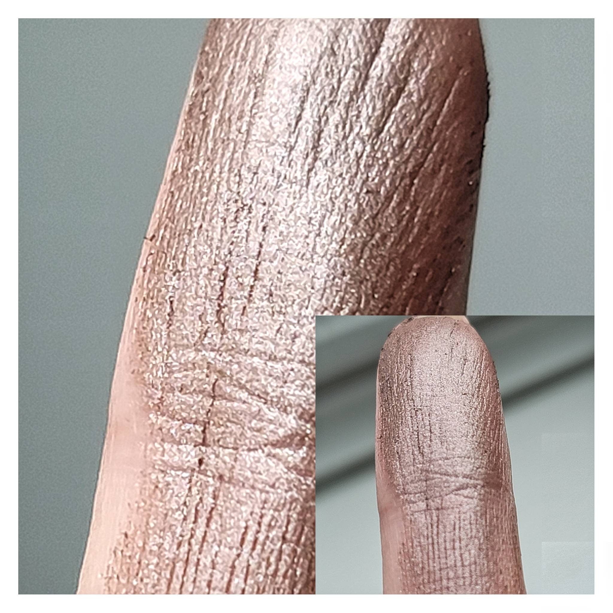 Side angle of Coco Bronze Beige Brown duochrome eyeshadow pan showing metallic chromatic shift in warm lighting