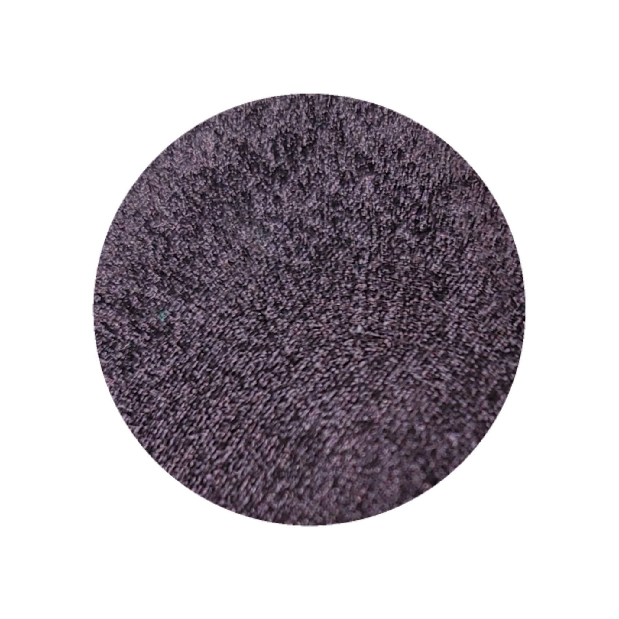 Close-up of vegan duochrome eyeshadow pan showing blackened burgundy to plum brown metallic color shift