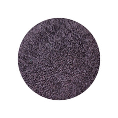 Close-up of vegan duochrome eyeshadow pan showing blackened burgundy to plum brown metallic color shift
