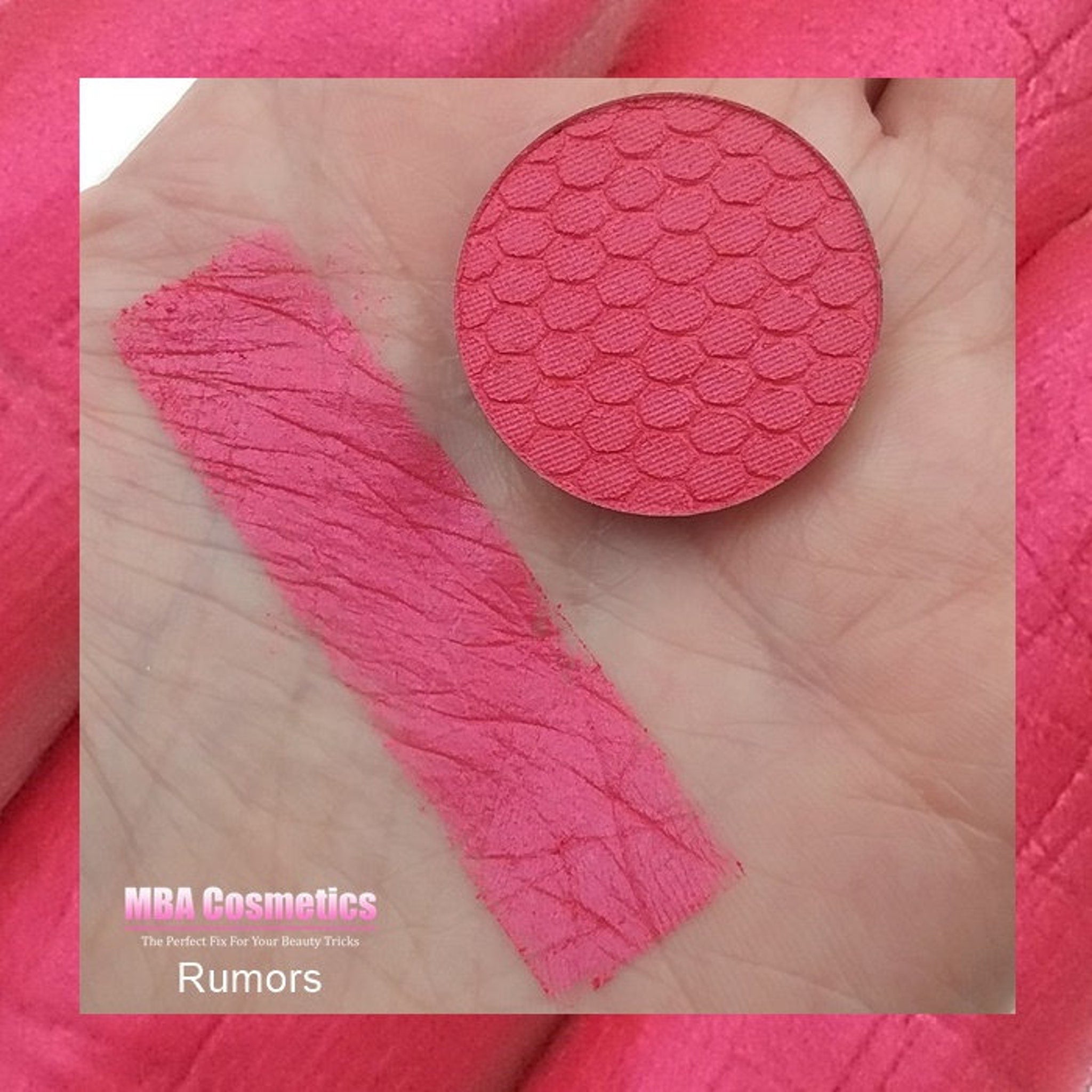 Side view of Pink Rumors pressed mineral eyeshadow showing compact size and smooth matte pink surface