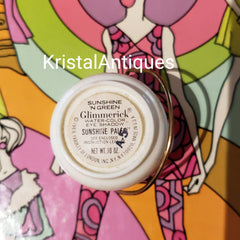 Vintage Glimmerick eye shadow, white container, gold stand, colorful background design