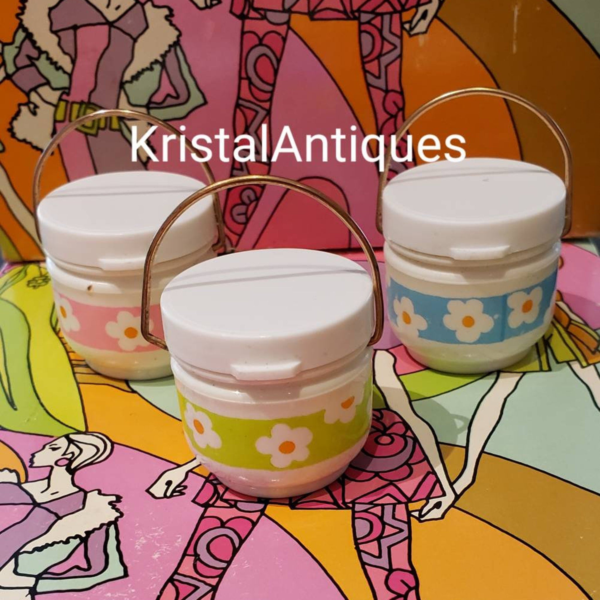White jars with floral pattern and gold handles, KristalAntiques text visible