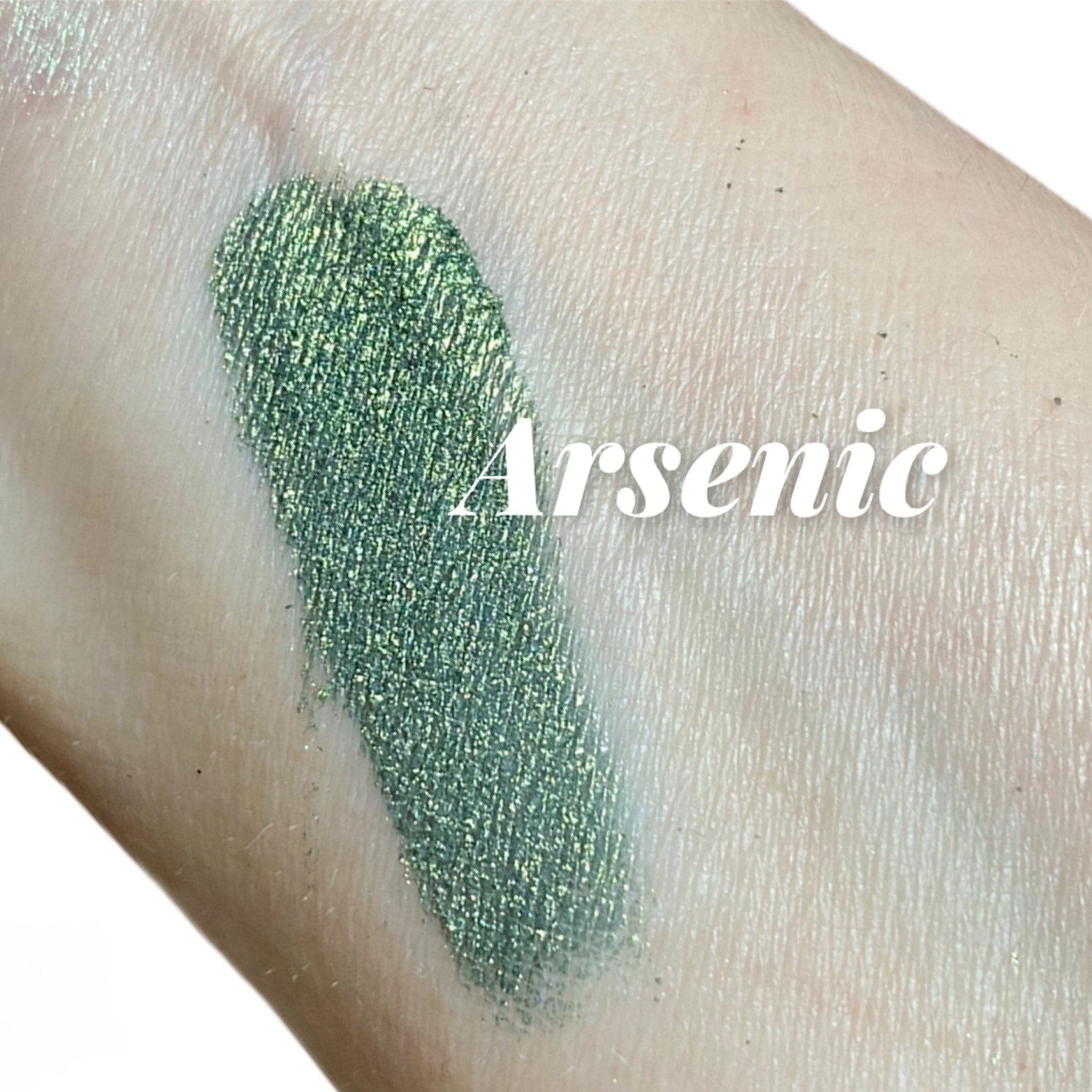Eyeshadow swatch, green shimmer, textured finish, Crush Arsenic text visible on skin