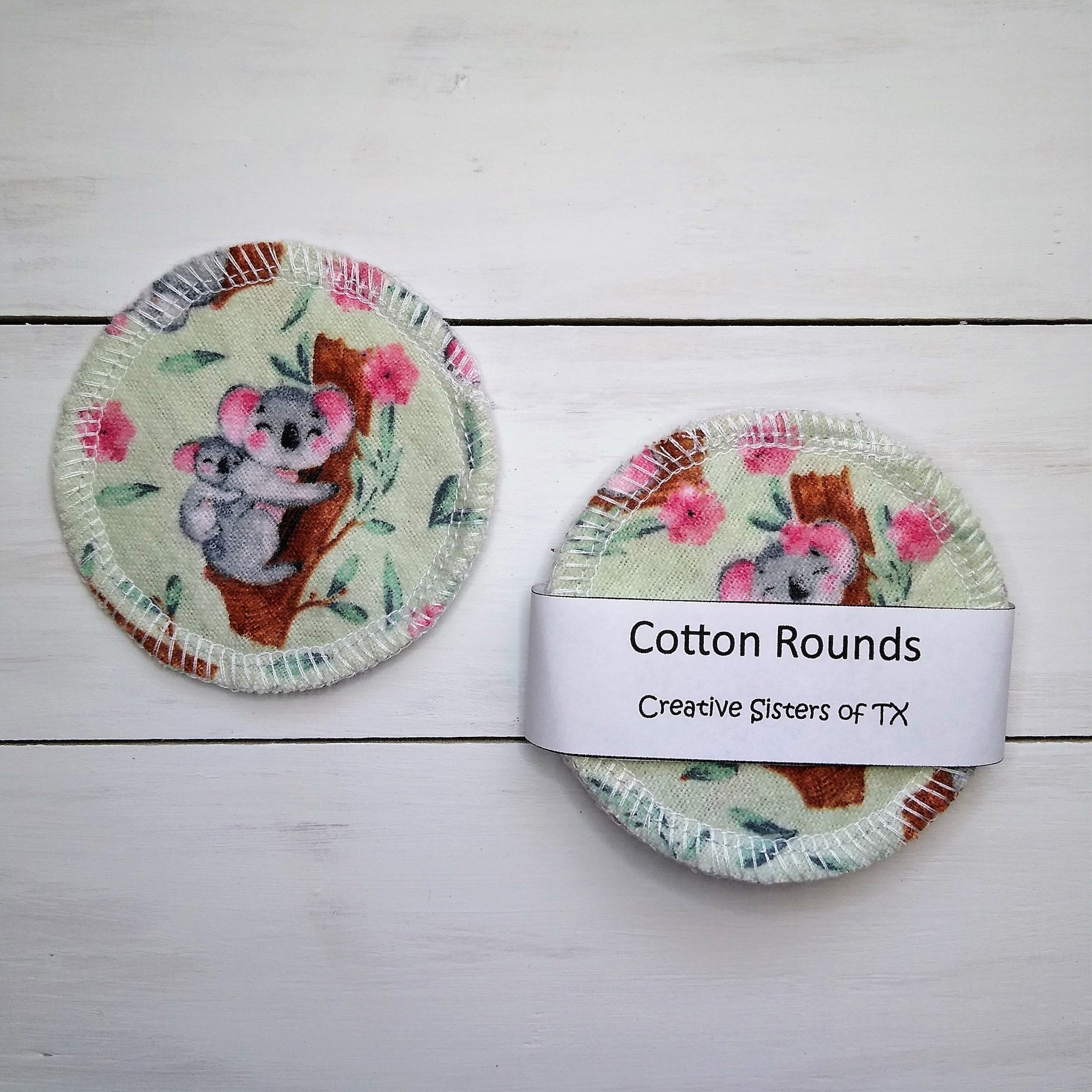Washcloths with koala print, light green fabric, and white stitching around edge