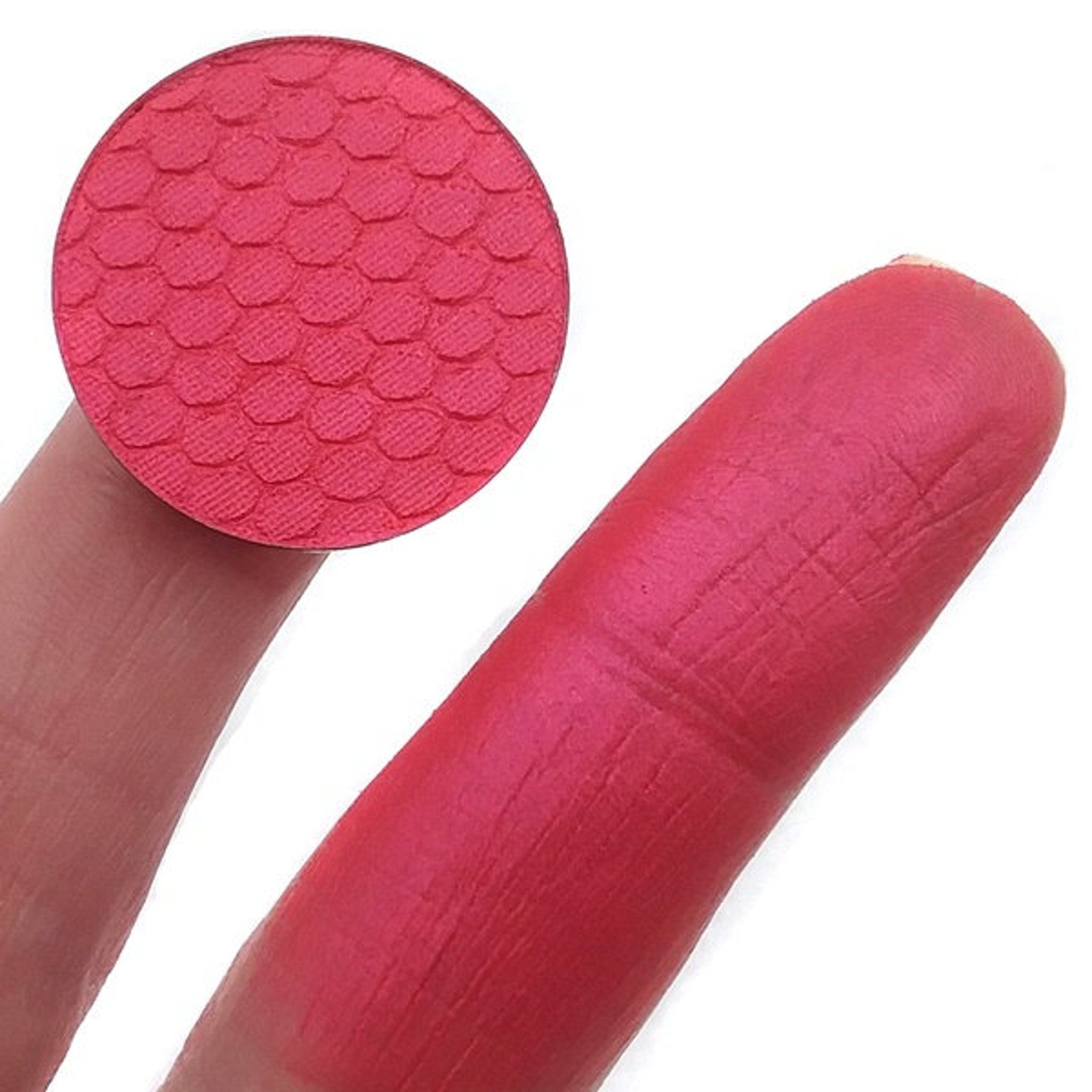 Close-up of pressed mineral eyeshadow in soft pink with shimmering pearl finish