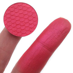 Close-up of pressed mineral eyeshadow in soft pink with shimmering pearl finish