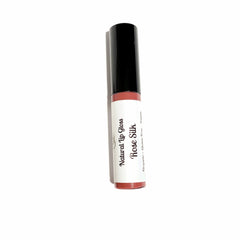 Lip gloss tube with black cap, white label, and Rose Silk text visible