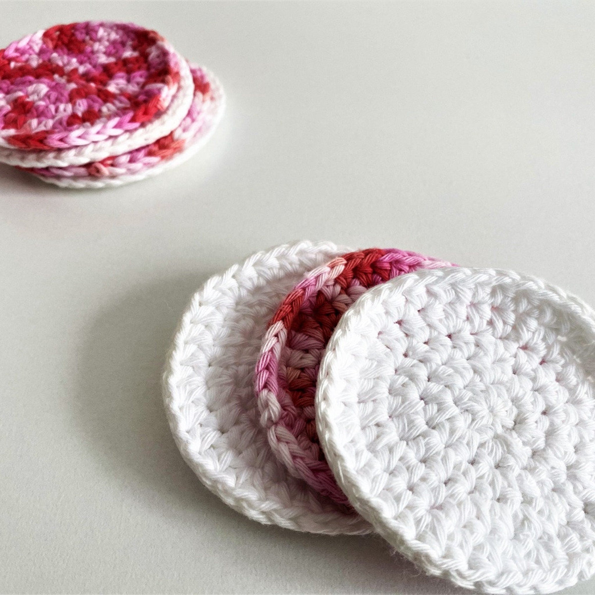 Reusable cotton pads with white, pink, and red crochet design for skincare use
