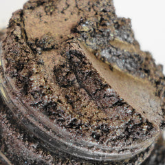 Side view of metallic brown gold vegan eyeshadow pan with pewter shimmer in compact packaging