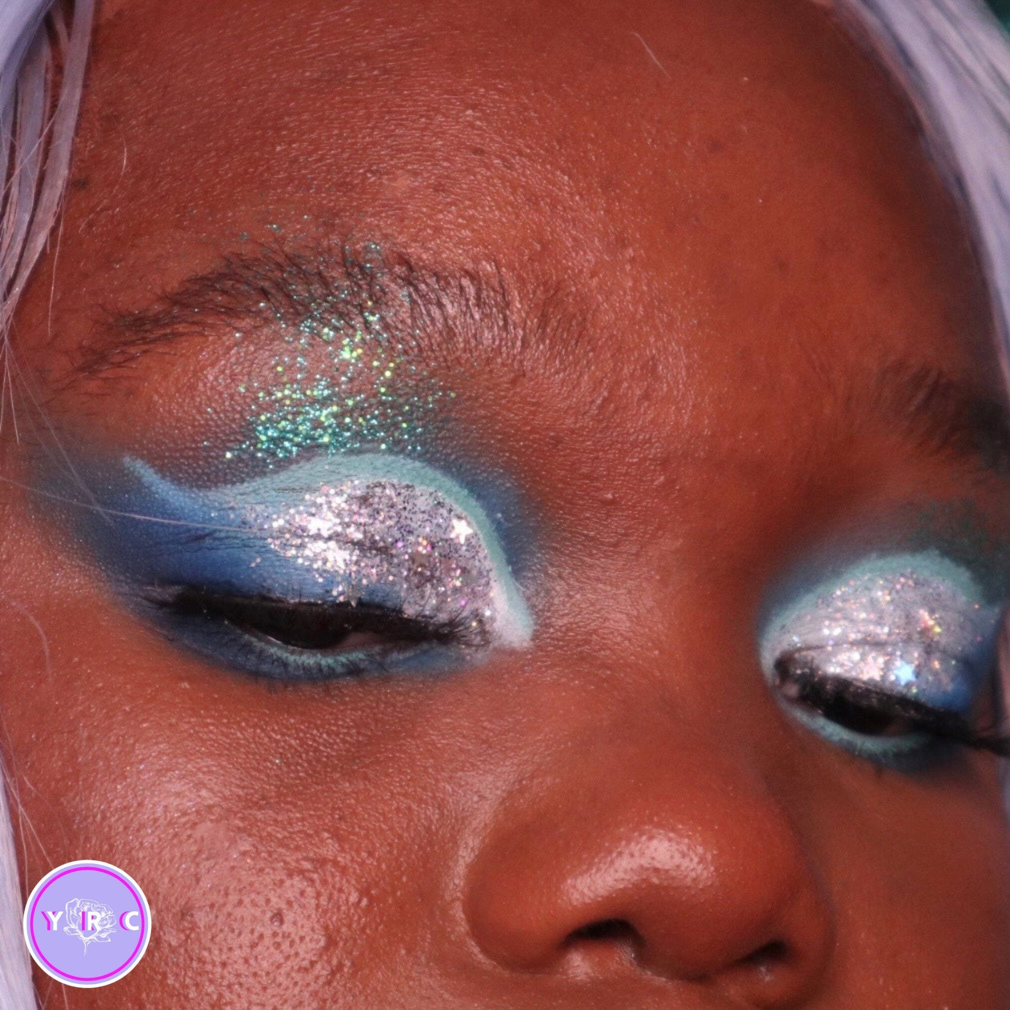 Side view of Sea Nymph Eye Shadow Bundle 2 showing stacked pans with teal, coral, and gold shimmery shades in compact palette